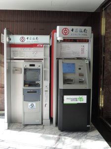 Bank of China ATM machine against a red wall indoors