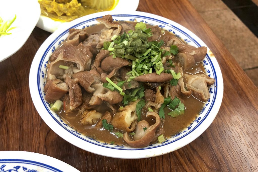 Bowl of Beijing luzhu huoshao with pork offal, tofu, and soaked flatbread
