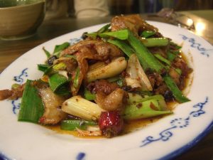 Plate of Sichuan twice-cooked pork with green peppers and garlic sprouts