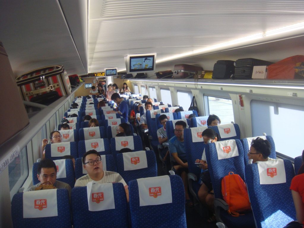Interior of a China high-speed train carriage with rows of passenger seats