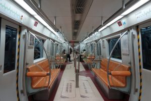 Interior of a Beijing Subway Line 1 train carriage with seats and handrails