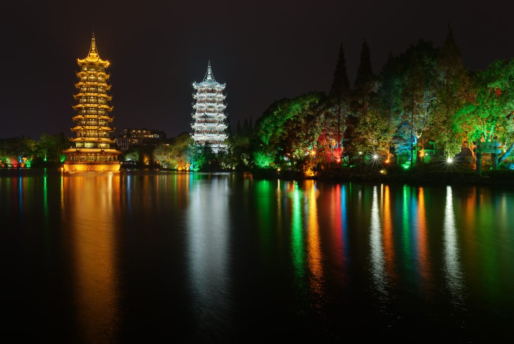 Illuminated Sun and Moon Pagodas on Shan Lake in Guilin at night