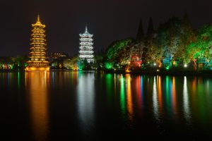 Illuminated Sun and Moon Pagodas on Shan Lake in Guilin at night