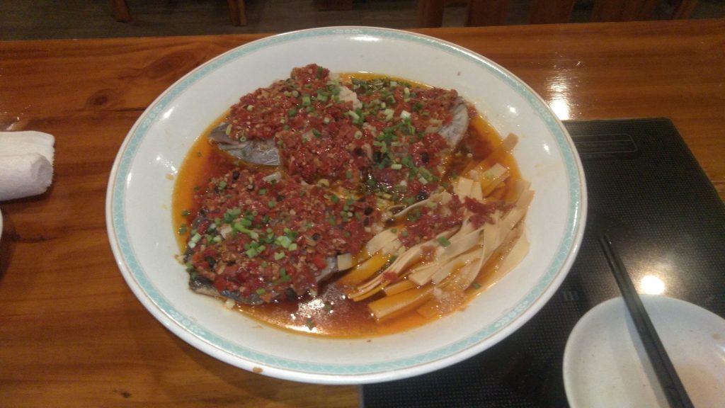 Hunan steamed fish head covered with bright red chopped chili sauce