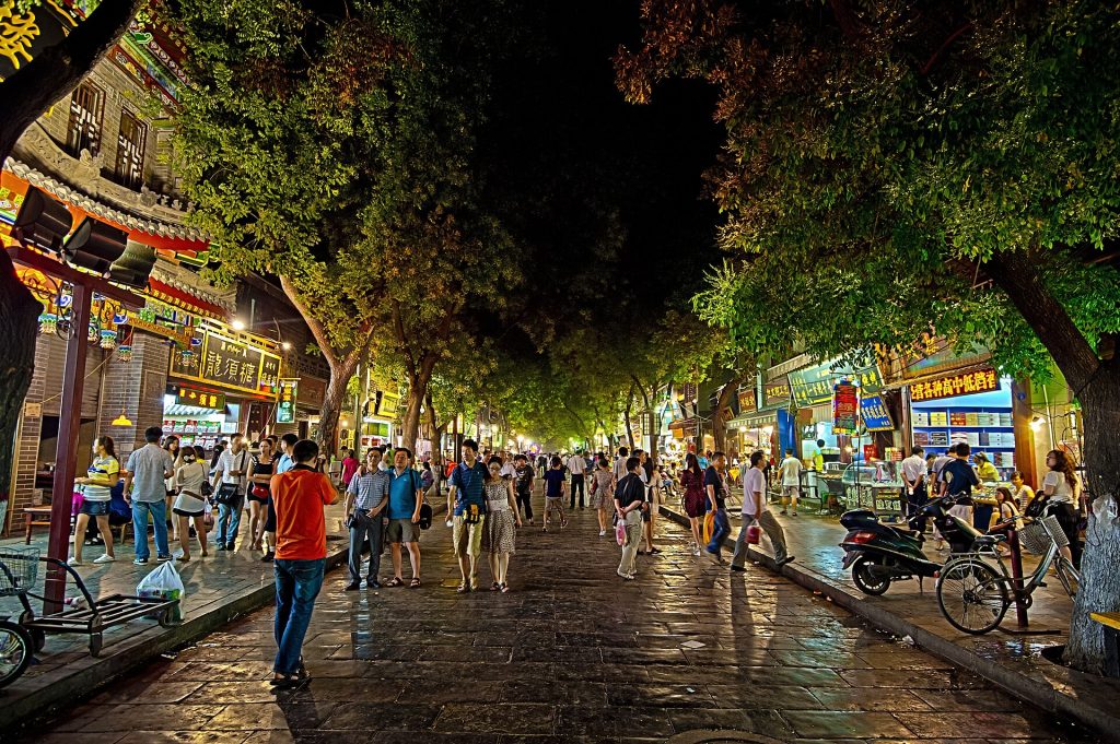 Night street scene in Xi'an Muslim Quarter with shop lights and crowds