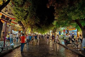 Night street scene in Xi'an Muslim Quarter with shop lights and crowds