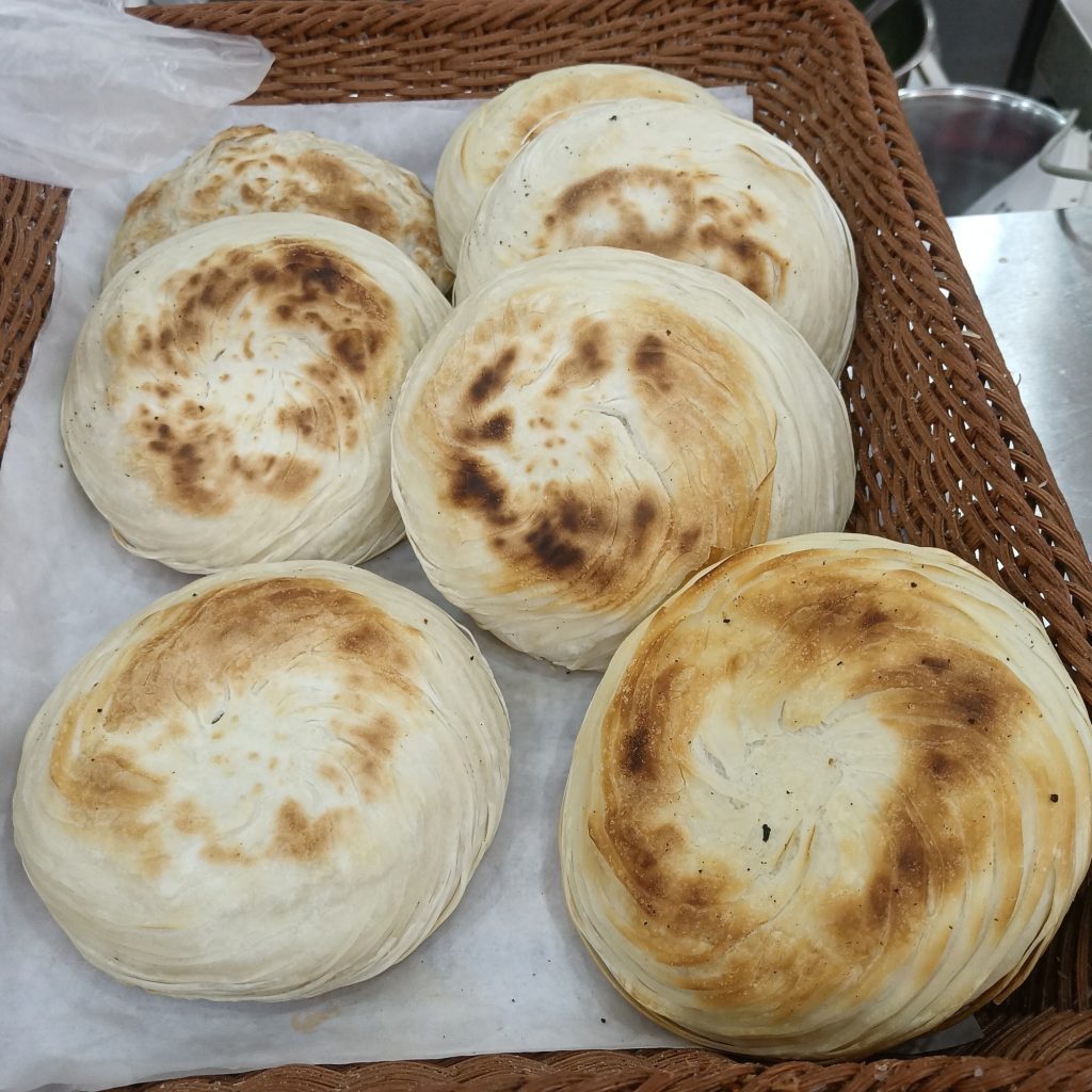 Cross-section of Xi'an thousand-layer rou jia mo with braised pork filling