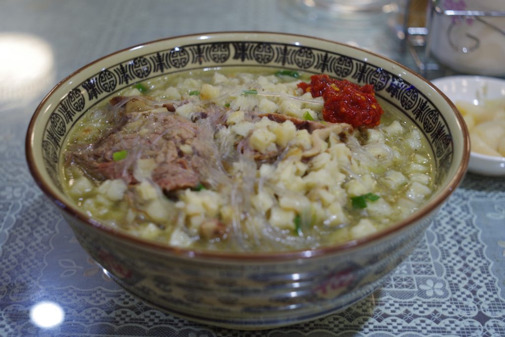 Bowl of Xi'an yangrou paomo lamb soup with torn bread
