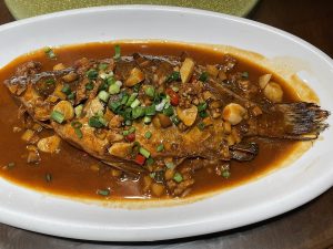Plate of Anhui fermented stinky mandarin fish (chou guiyu) with red chillies and sauce