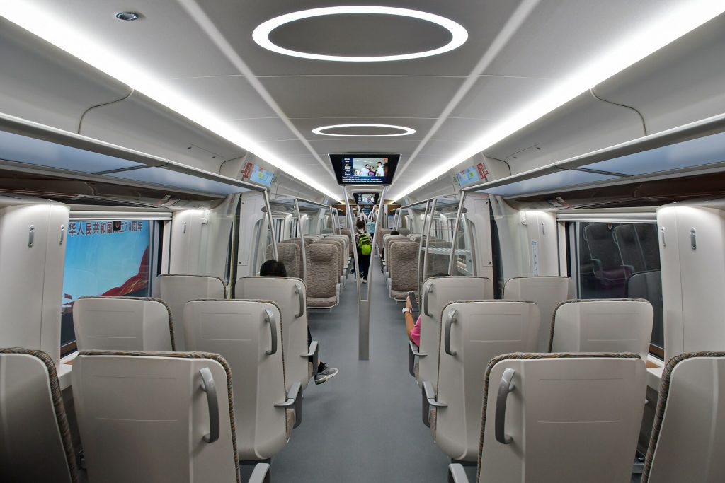 Airport express train doors open at a modern elevated station platform