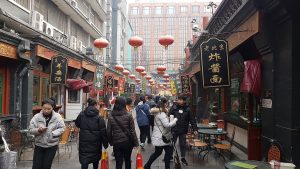 Busy Wangfujing Snack Street stalls in Beijing with traditional snacks on display