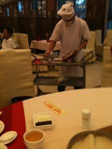 Beijing roast duck carved tableside with pancakes and condiments