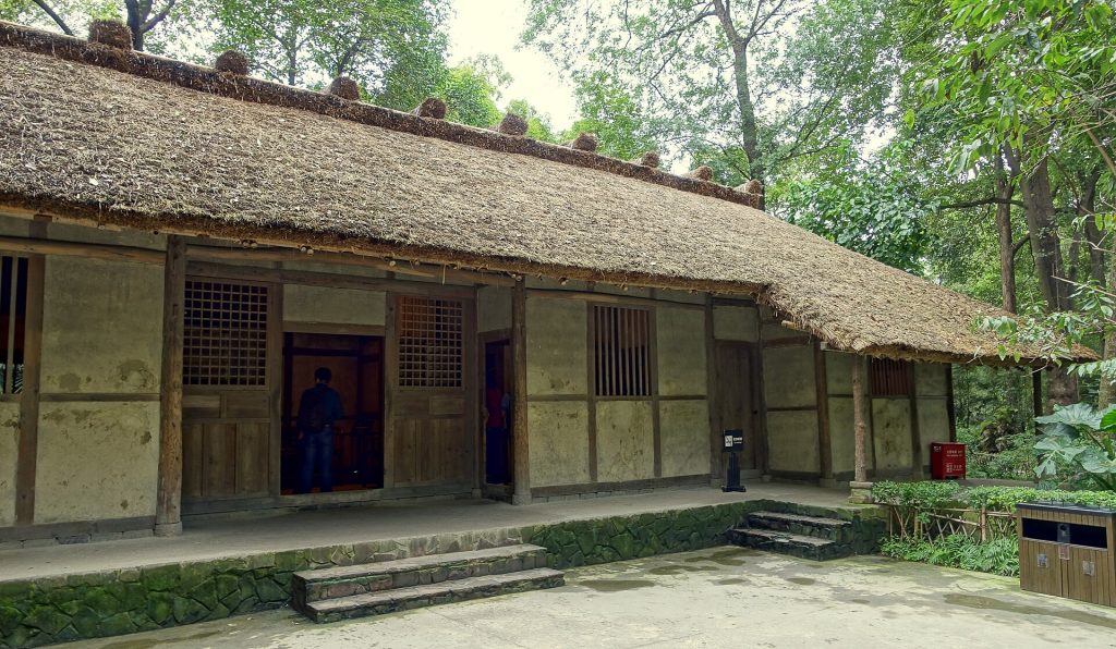 Traditional thatched cottage buildings among trees at Chengdu’s Du Fu Thatched Cottage