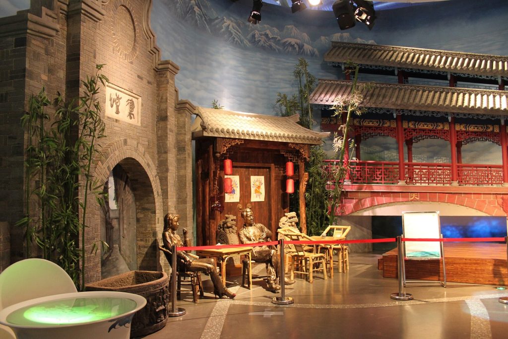 Chengdu city street with tea house seating and tree shade