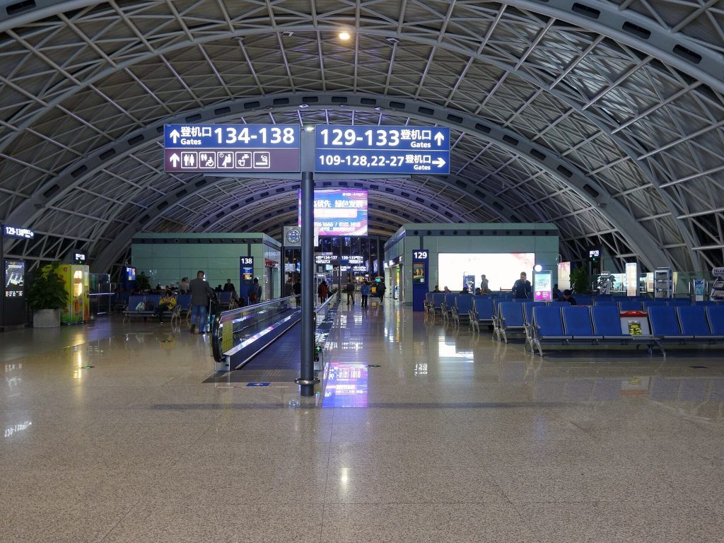 Airport terminal departure hall with passport control signs in China