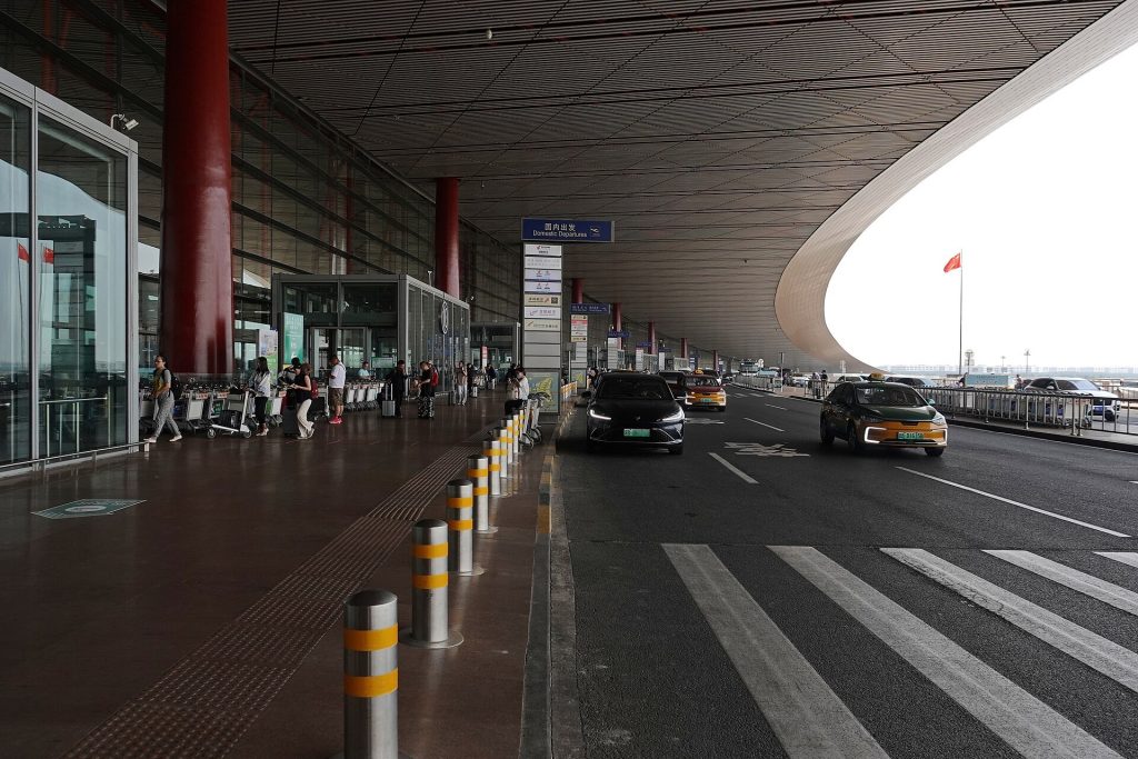 Interior of Beijing Capital International Airport Terminal 3 with curved roof beams and check-in halls