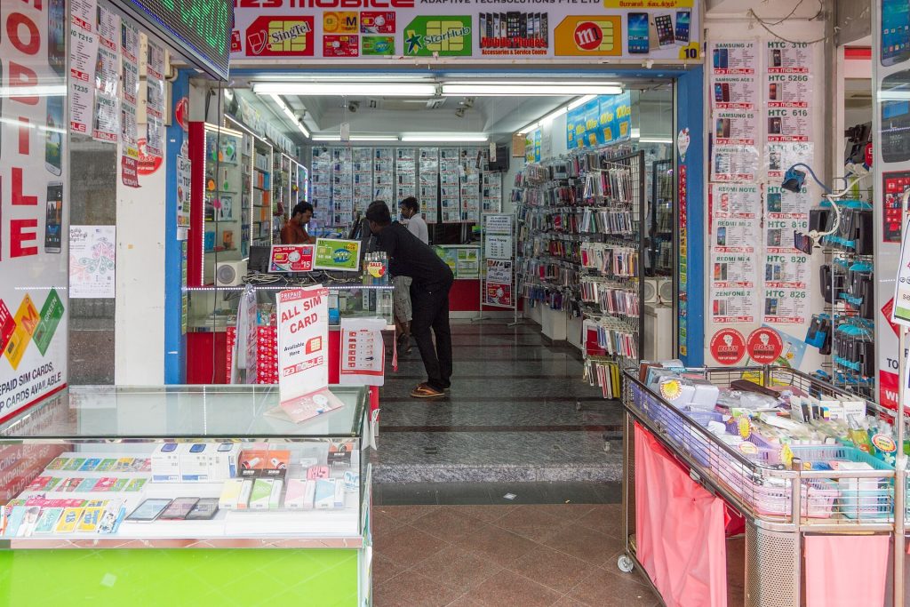 Mobile phone shop counter with SIM packs and passport on the desk