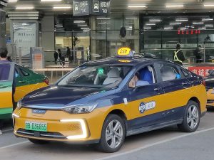 Yellow city taxi on a street in China