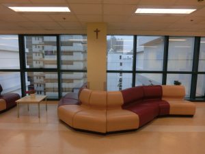 Hospital reception desk with payment window and waiting area chairs