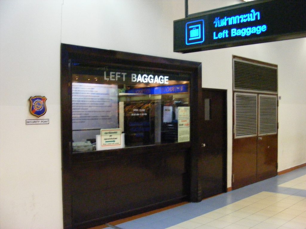 Travellers storing suitcases at a staffed left-luggage counter