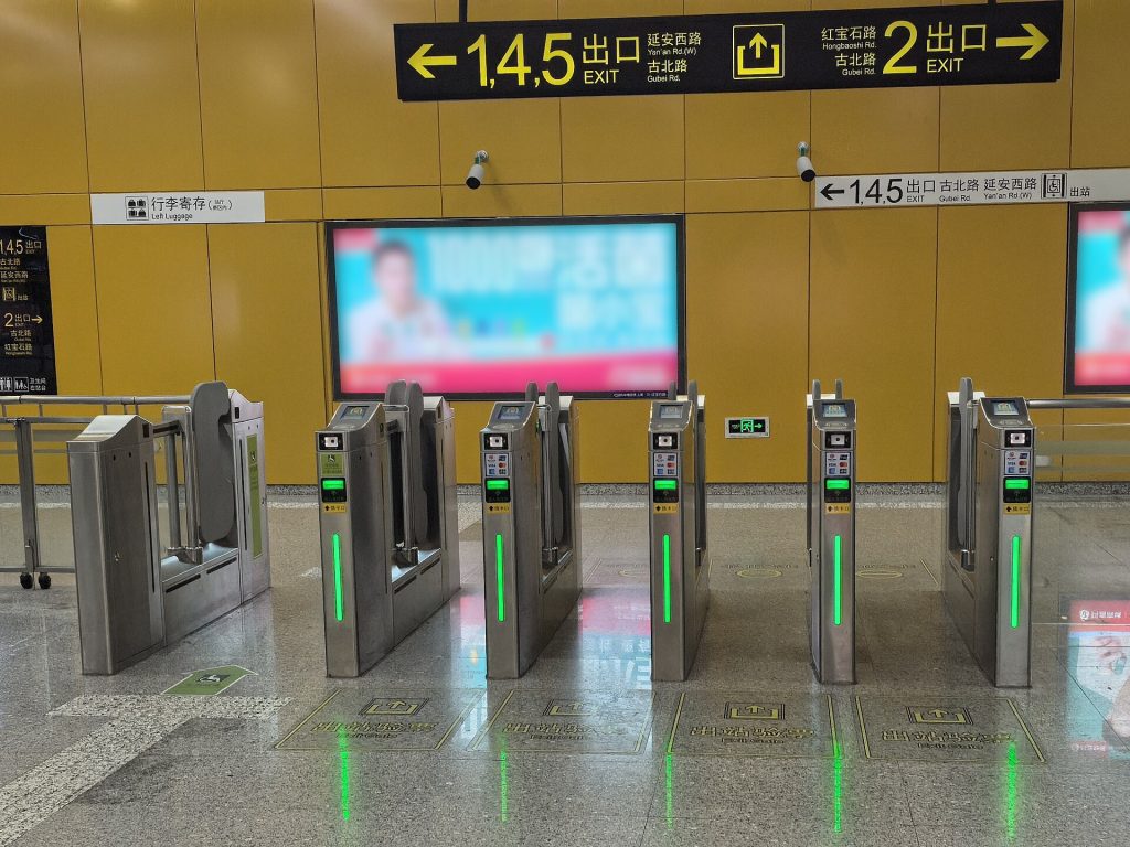 Metro ticket gates and transit card readers in a Chinese subway station