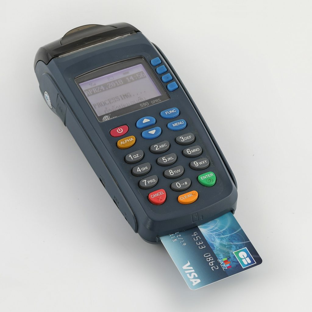Payment terminal and bank card logos at a retail checkout counter