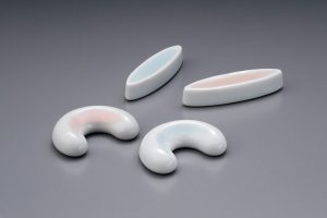 Pair of chopsticks resting on a ceramic holder at a Chinese table