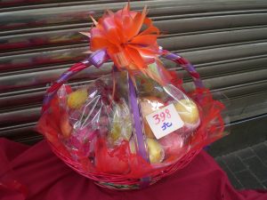 Wrapped gift box and fruit basket on a Chinese living room table