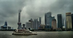Foggy rainy day view across a Shanghai riverfront with muted grey skyline