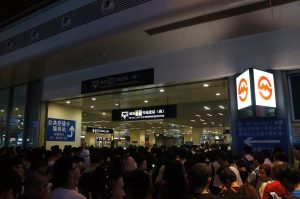 Dense crowd of travelers outside the southern metro entrance of Shanghai Hongqiao Railway Station