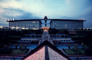 Guangzhou Baiyun Airport terminal hall with travellers and luggage carts