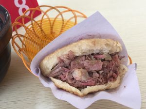 Baoding-style donkey burger with chopped donkey meat stuffed in a round crisp huoshao bread pocket