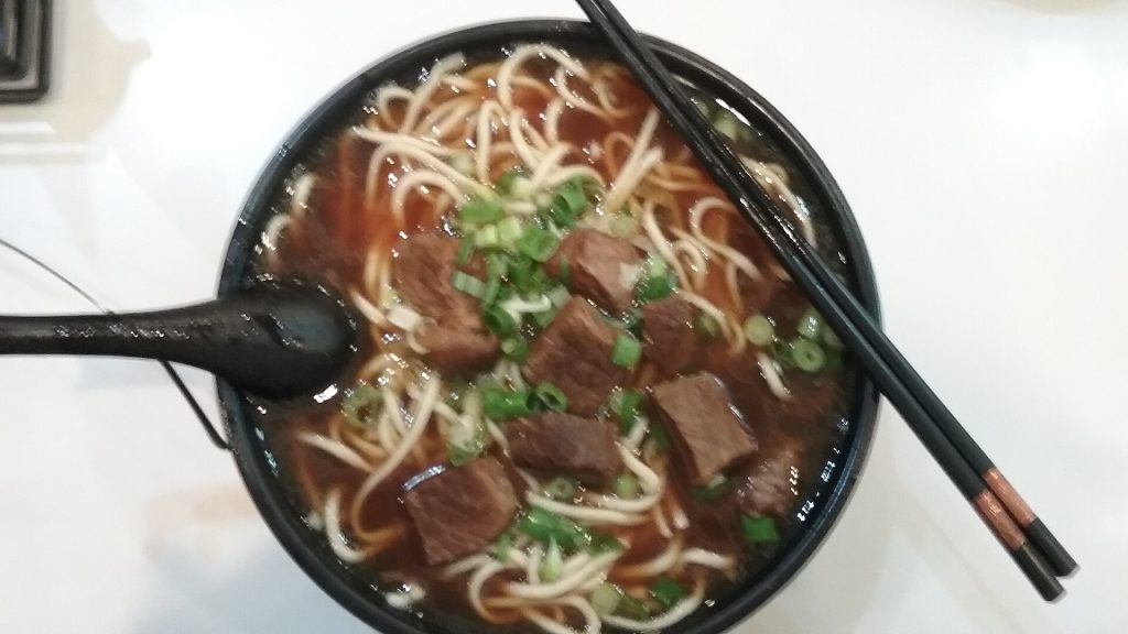 Bowl of Chinese braised noodle soup with beef and vegetables