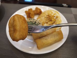 Hotel restaurant breakfast buffet tables with food trays and serving stations in Shantou, Guangdong