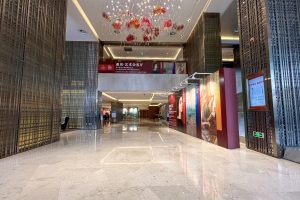 Entrance lobby interior of a hotel in Beijing with seating and reception levels visible