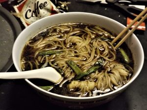 Bowl of yangchun-style soy sauce noodle soup with clear broth and thin wheat noodles