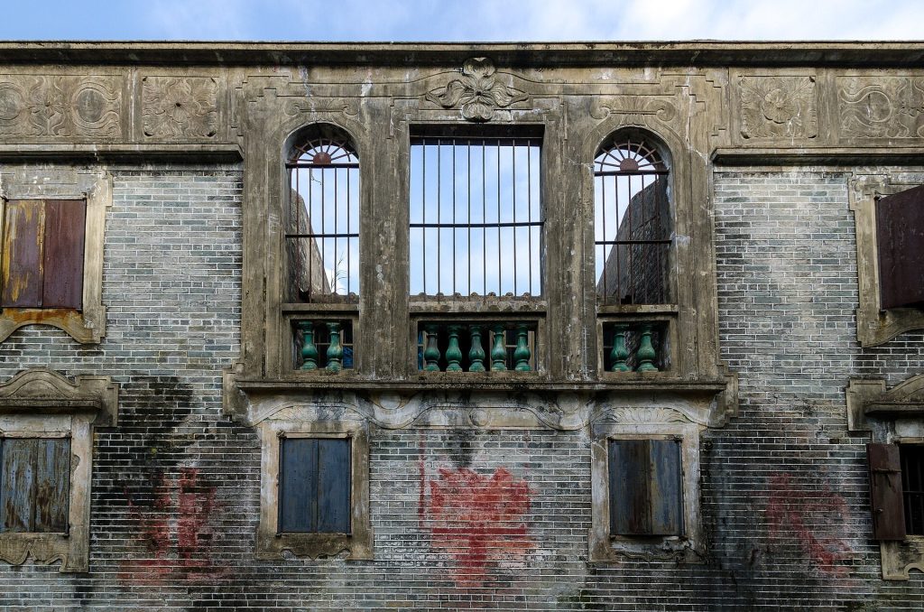 Multi-story diaolou watchtower rising above village fields in Kaiping, Guangdong