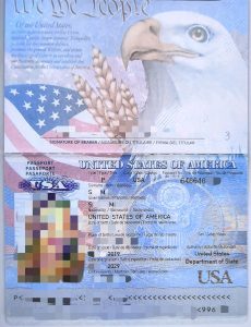 Passport and travel documents on a table beside a city map