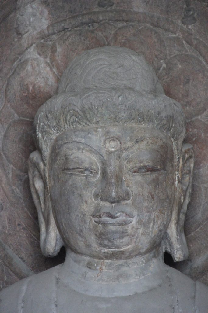 Stone Buddha statues carved into the cliffs at Longmen Grottoes, Luoyang