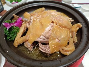 Plate of Dongjiang Hakka-style salt-baked chicken pieces with golden skin, closely related to Meizhou yanjuji