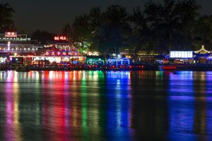Beijing Shichahai lake at dusk with willow trees and soft evening lights