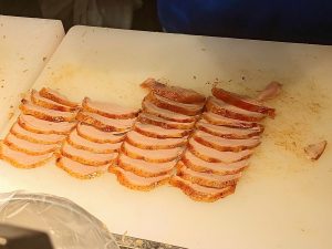 Sliced Peking duck arranged on a plate ready for wrapping