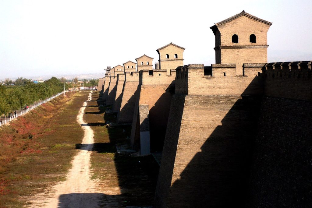Ancient city walls and gray-brick lanes of Pingyao, Shanxi, under clear autumn light