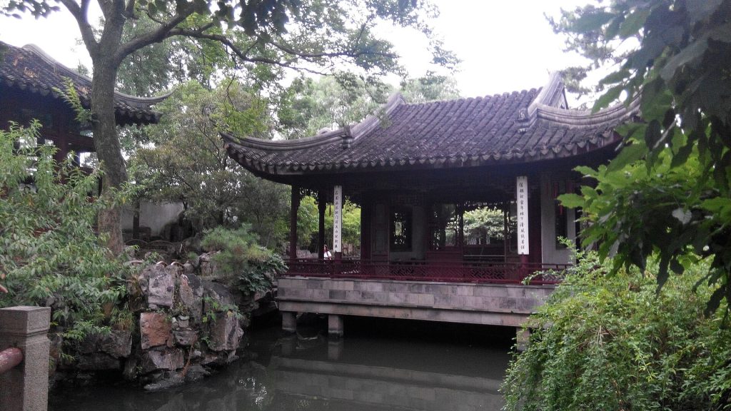 Classical Chinese garden pavilion and pond in Suzhou under soft daylight