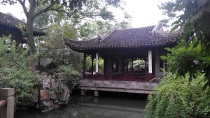 Classical Chinese garden pavilion and pond in Suzhou under soft daylight