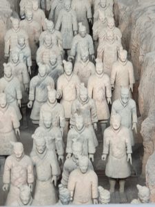 Terracotta Warriors pit museum hall with visitors viewing ranks of statues
