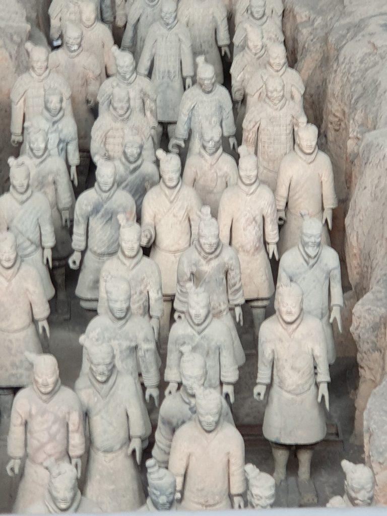 Terracotta Warriors pit museum hall with visitors viewing ranks of statues
