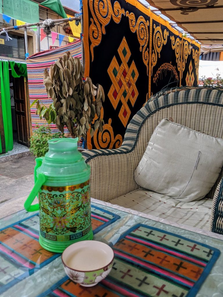 Thermos and cup of Tibetan yak butter tea served at a teahouse in Lhasa