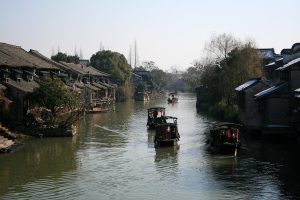 Stone bridges and canal houses lining a quiet waterway in Wuzhen, Zhejiang