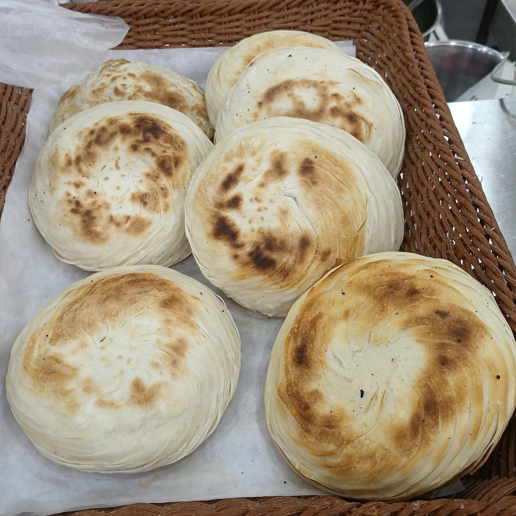 Freshly stuffed Chinese meat bun cut open showing braised pork filling
